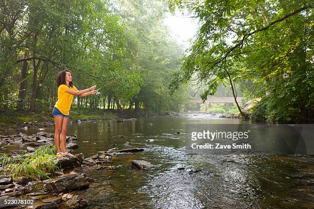 young woman fishing in stream, coatesville, pennsylvania, usa - coatesville stock pictures, royalty-free photos & images