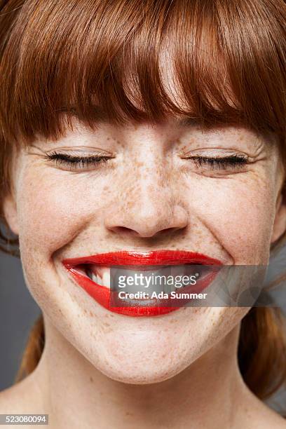 young woman wearing lipstick, smiling - rossetto foto e immagini stock