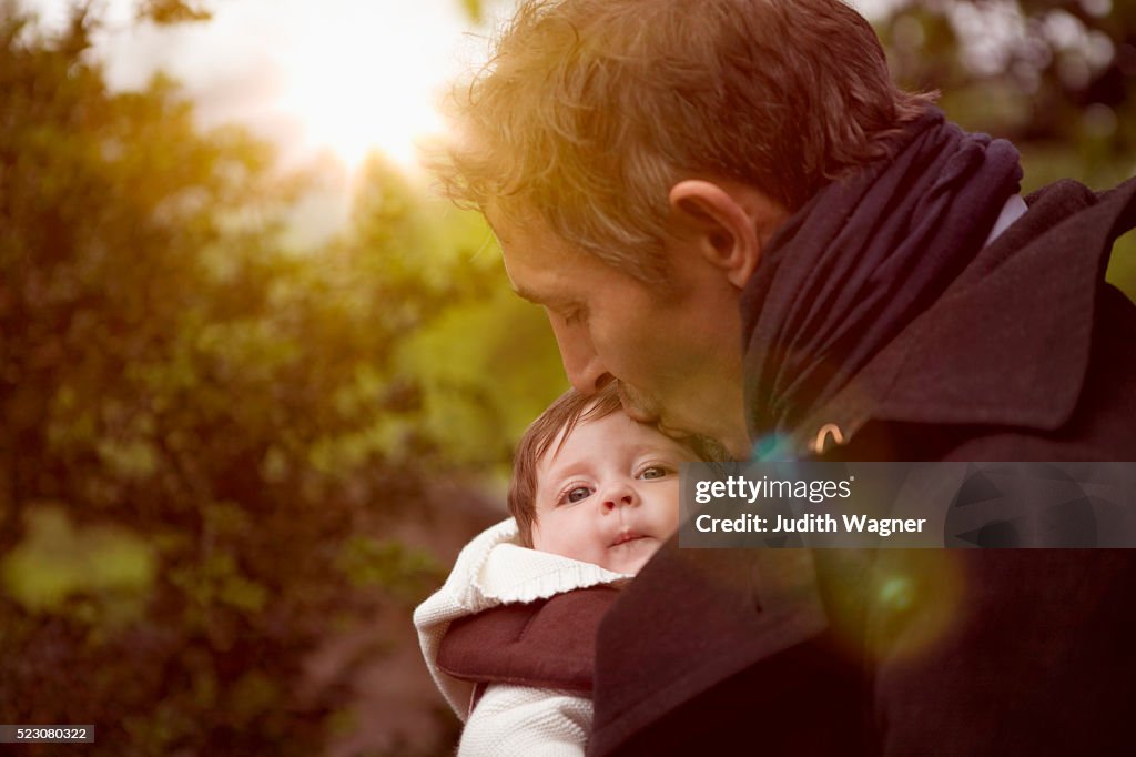 Father kissing baby (2-5 months)