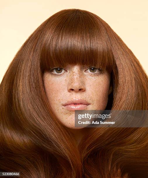 studio portrait of young woman with long brown hair - hair color stock pictures, royalty-free photos & images