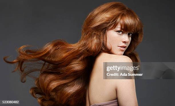 studio portrait of young woman with long hair - redhead stock pictures, royalty-free photos & images