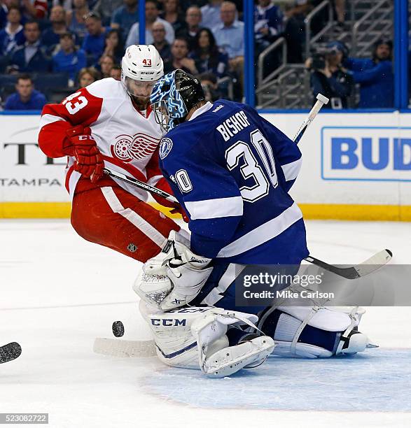 Ben Bishop of the Tampa Bay Lightning makes a save against Darren Helm of the Detroit Red Wings during the third period in Game Five of the Eastern...