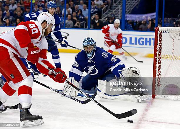 Ben Bishop of the Tampa Bay Lightning makes a save against Henrik Zetterberg of the Detroit Red Wings during the third period in Game Five of the...