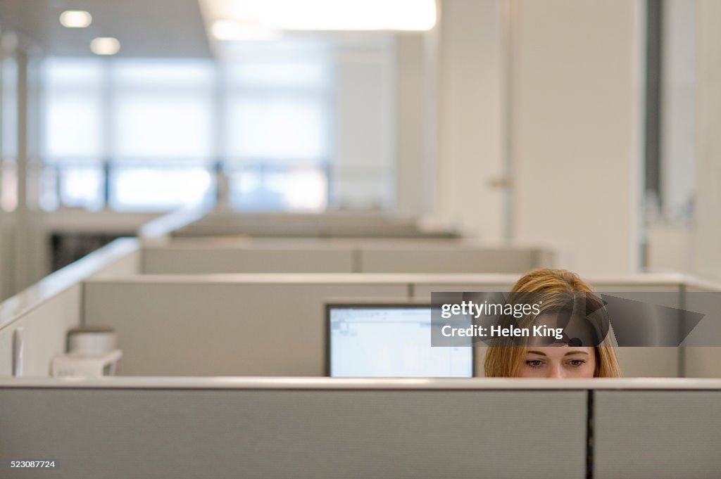 Businesswoman working in a cubicle