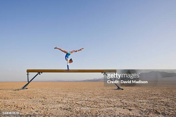 girl performing on balancing beam in the desert - 平均台 ストックフォトと画像