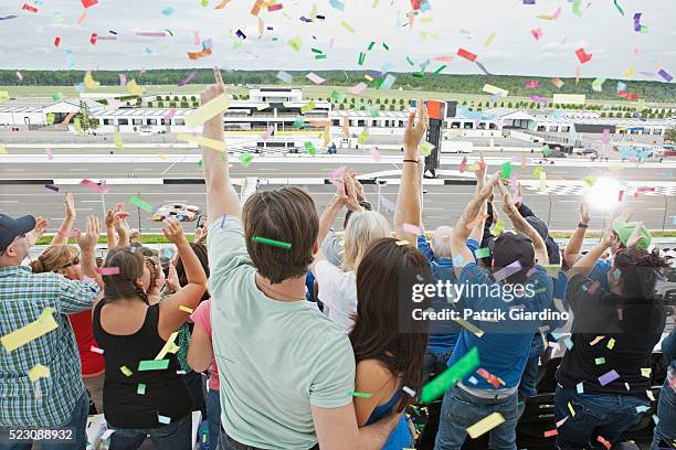 spectators watching car racing - nascar rennen stock-fotos und bilder