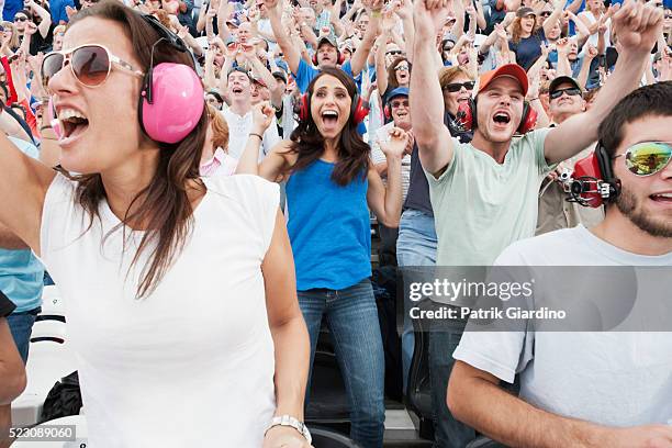 spectators watching car racing - women motorsport stock pictures, royalty-free photos & images