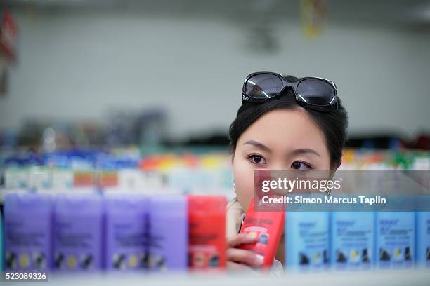 woman smelling shampoo - shampoo stock pictures, royalty-free photos & images