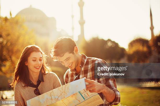 turkish couple use paper map - turkisk kultur bildbanksfoton och bilder