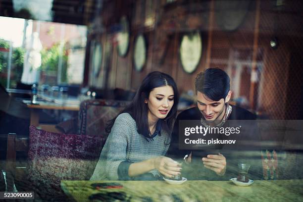 turkish couple in cafe use tablet - turkish people cafe stock pictures, royalty-free photos & images