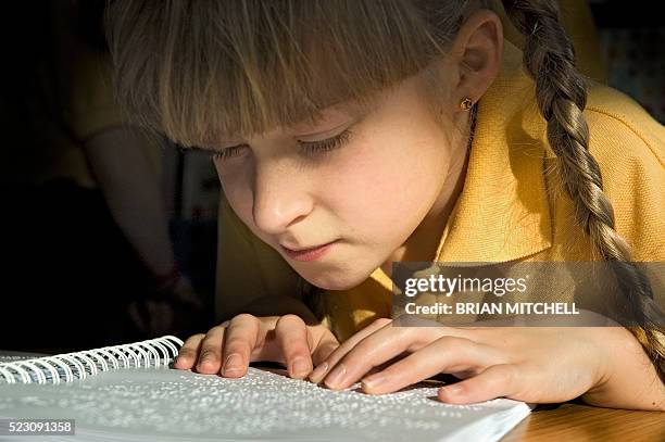blind 9 year old girl reading a braille book - blind girl stock pictures, royalty-free photos & images