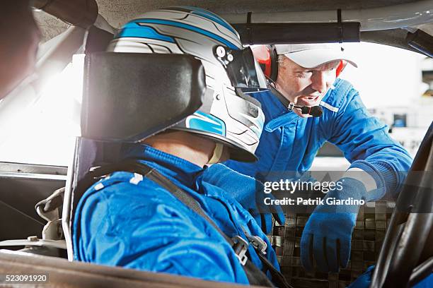 crew member and stock car driver communicating - stock car racing stock-fotos und bilder