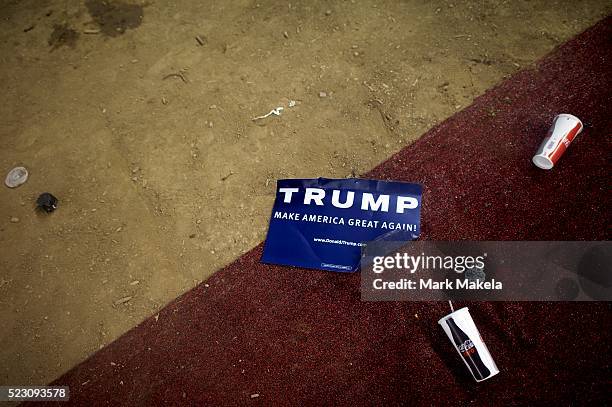 Donald Trump campaign yard signs and trash remain following a rally with the Republican presidential candidate at the Pennsylvania Farm Show Complex...