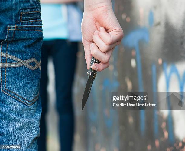 boy threatening a girl with a knife - child aggression stock pictures, royalty-free photos & images