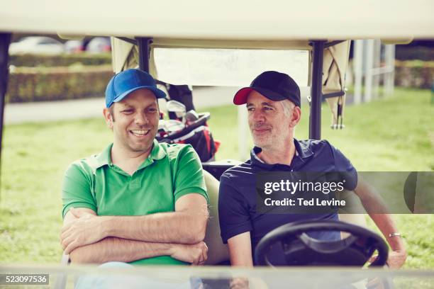 men talking on golf cart - golfer stock pictures, royalty-free photos & images