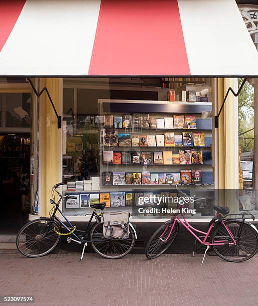 bicycles parked outside bookstore - awning window fotografías e imágenes de stock