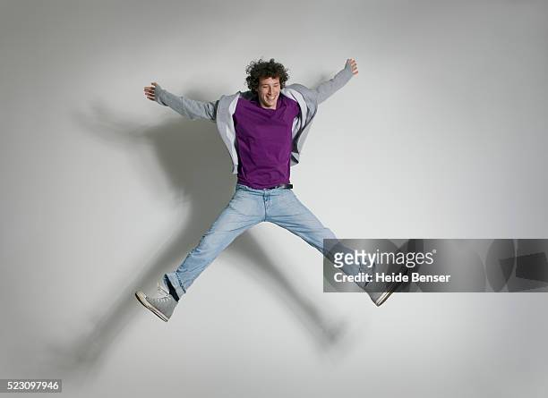 young man jumping - man mid air stock pictures, royalty-free photos & images