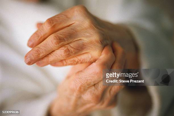 old woman's hands - arthritis stock-fotos und bilder