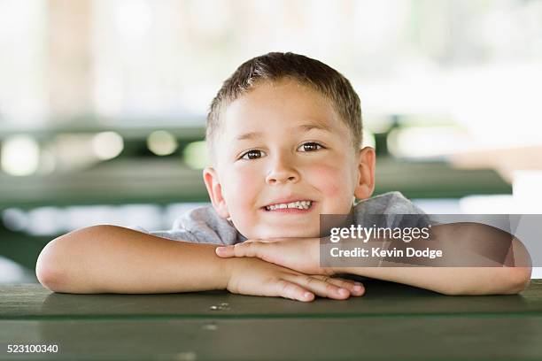 happy little boy - hand on chin stock pictures, royalty-free photos & images
