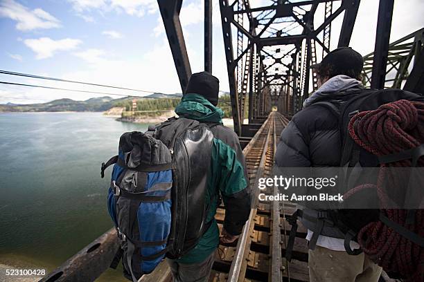 climbers walking across a trestle bridge - spokane stock pictures, royalty-free photos & images
