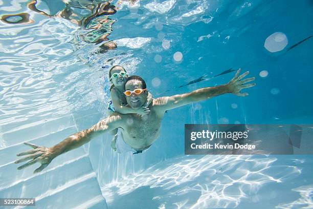 father and daughter swimming together - family swimming stock pictures, royalty-free photos & images