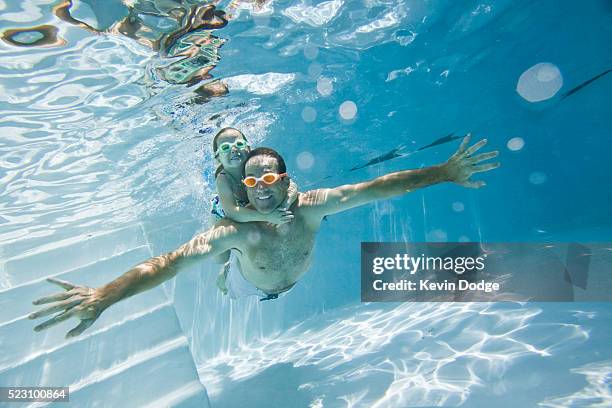 father and daughter swimming together - swimming goggles stock pictures, royalty-free photos & images