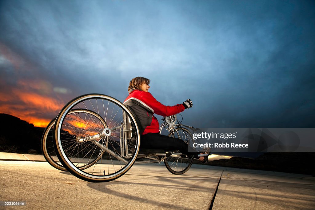 A female para-athlete rides her handcycle