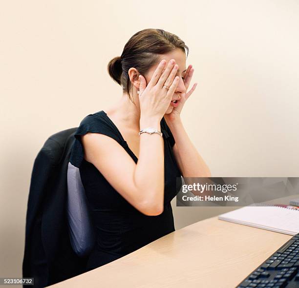 stressed businesswoman at desk - archival office stock pictures, royalty-free photos & images