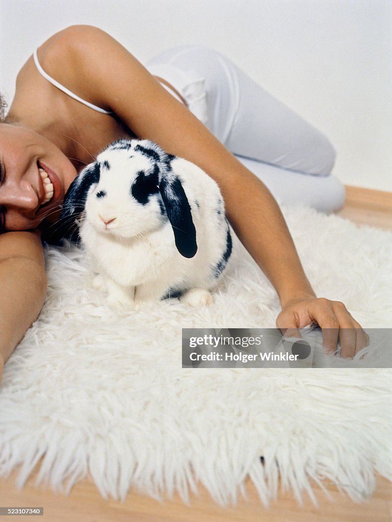 Pampered Rabbit Young Woman On Furry Rug With Pampered Pygmy Rabbit High-Res Stock ...