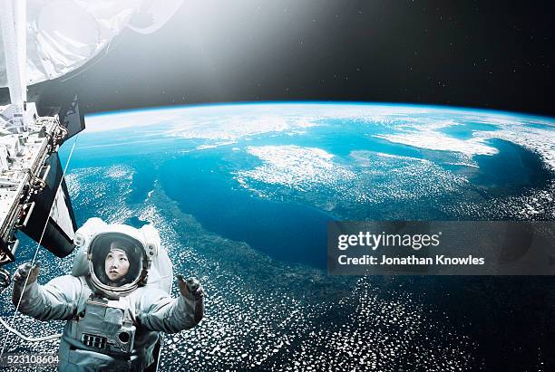 astronaut floating in space - space station stock pictures, royalty-free photos & images