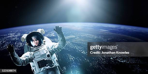 astronaut floating in space - spacewalk stock pictures, royalty-free photos & images