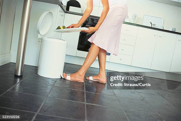 woman using flip top waste basket - white trash stock-fotos und bilder