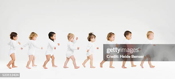 toddlers walking in a line - 1歳以上2歳未満 ストックフォトと画像