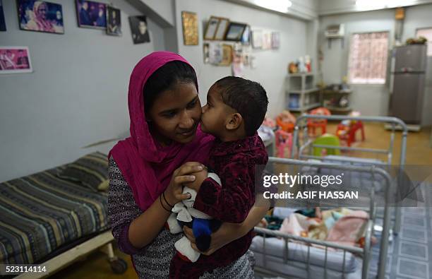 In this photograph taken on February 15 a staff member plays with an abandoned child at a welfare office of the Edhi Foundation in the port city of...