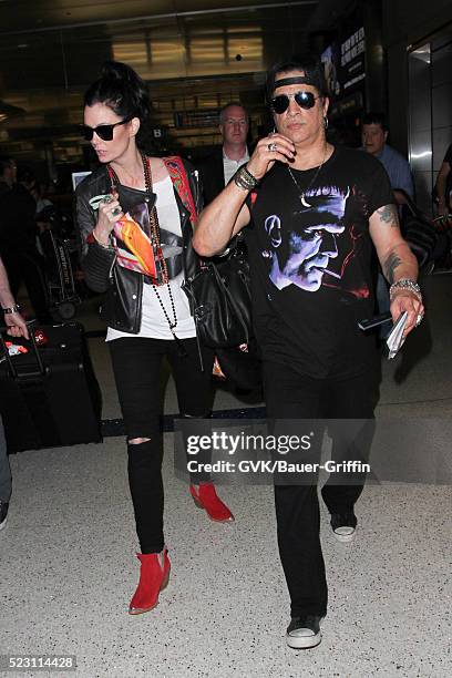 Slash and Meegan Hodges are seen at LAX on April 21, 2016 in Los Angeles, California.