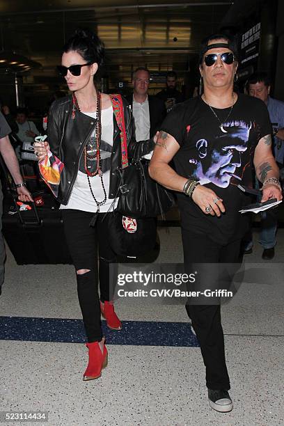 Slash and Meegan Hodges are seen at LAX on April 21, 2016 in Los Angeles, California.