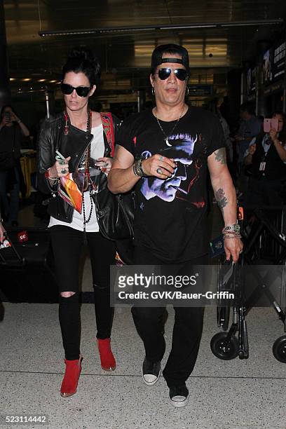 Slash and Meegan Hodges are seen at LAX on April 21, 2016 in Los Angeles, California.