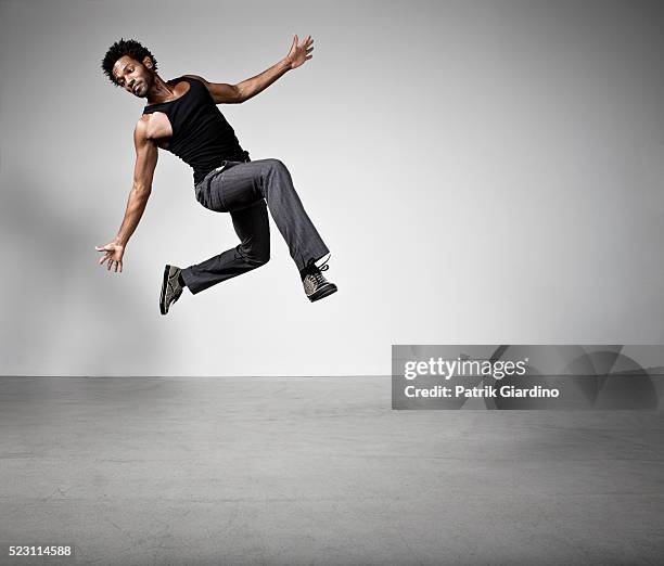 young man jumping - young men dance stock pictures, royalty-free photos & images