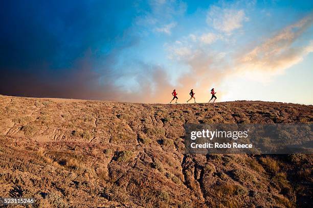 three women trail running in desert at sunrise, grand junction, mesa county, colorado, usa - クロスカントリー競技 ストックフォトと画像
