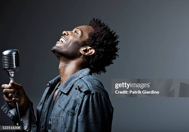 young man singing - black man looking up stock pictures, royalty-free photos & images