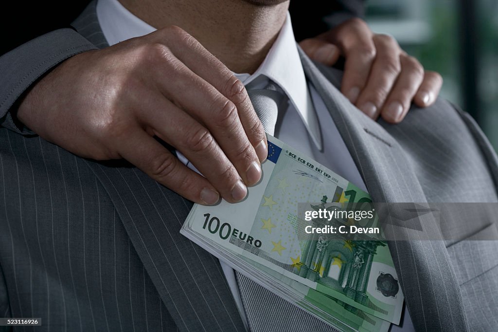 Businessman Being Bribed with Euros
