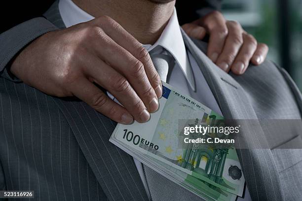 businessman being bribed with euros - corruzione foto e immagini stock