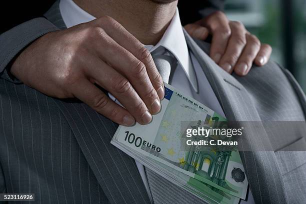 businessman being bribed with euros - 汚職 ストックフォトと画像