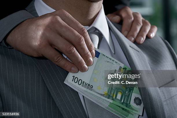 businessman being bribed with euros - corrupção imagens e fotografias de stock
