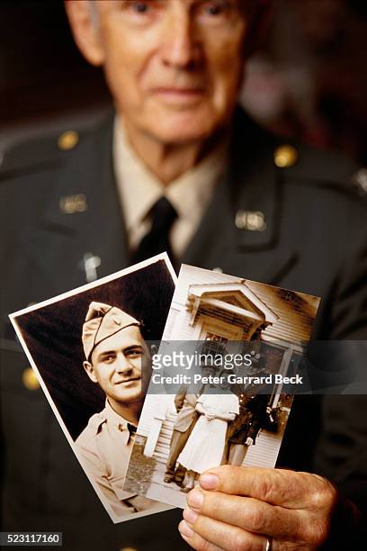 world war ii veteran holding photographs - war veteran bildbanksfoton och bilder