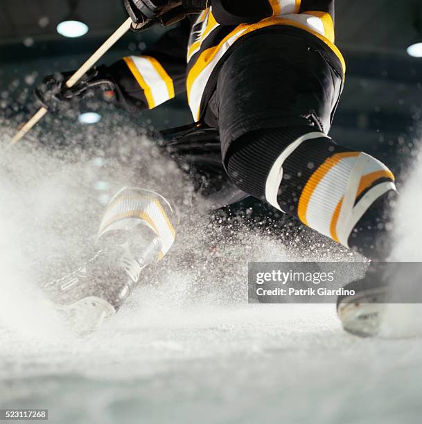 hockey player turning on ice - hockey skating stock pictures, royalty-free photos & images