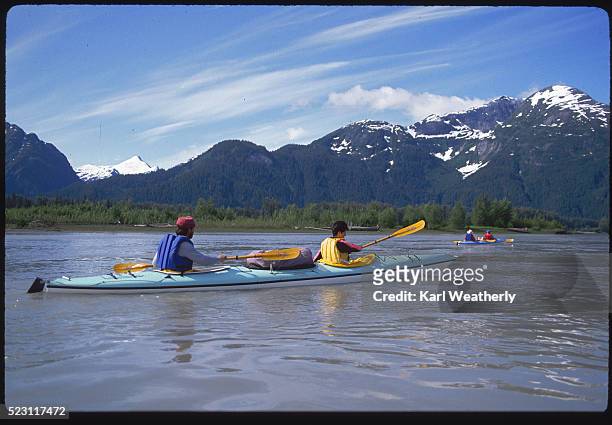kayakers on the stikine river in alaska - stikine river stock pictures, royalty-free photos & images