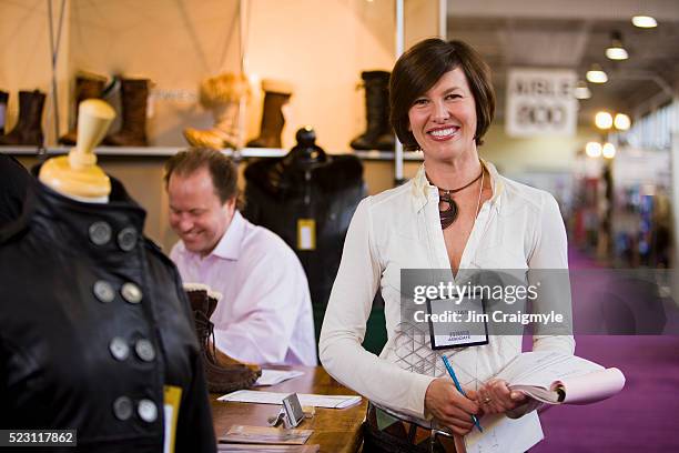 woman with clothing booth at trade fair - tradeshow ストックフォトと画像