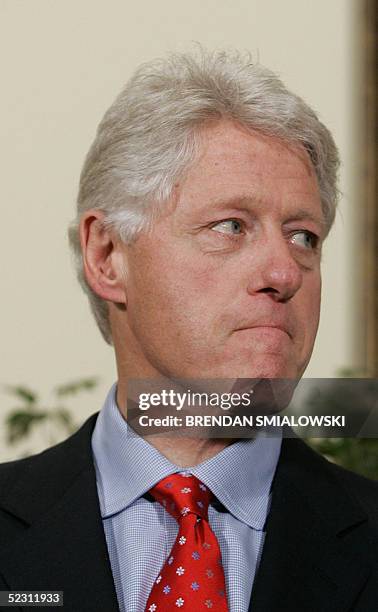 Former US President Bill Clinton listens to questions while talking with reporters in the Roosevelt Room of the White House 08 March, 2005 in...
