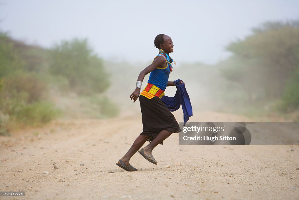 Arbore Woman Running Across Road
